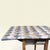 Polychrome table with a diamond-patterned patina in shades of gray, white, and beige. It can be used as a console table...