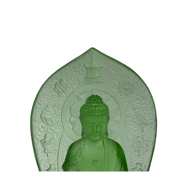 This green glass sculpture features a seated Buddha in a meditative pose atop an ornate lotus pedestal. Crafted with a...