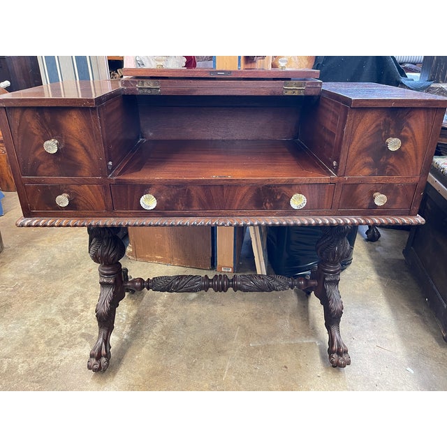 This historically important desk has carved acanthus leaf trestle legs and flame mahogany veneers, a furniture style...