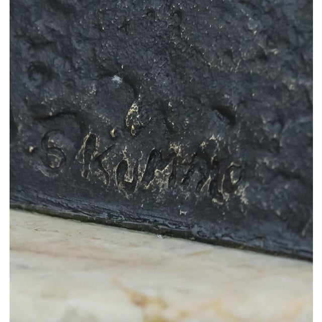 Sydney Kumalo. Features a bronze stylized female figural form sculpture fixed to a marble plinth and wood base. Bears...