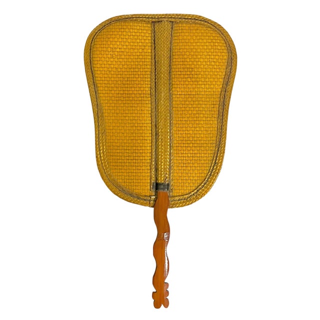 Add an effortless layer of texture and collected charm with this vintage woven rattan hand fan featuring a beautifully...