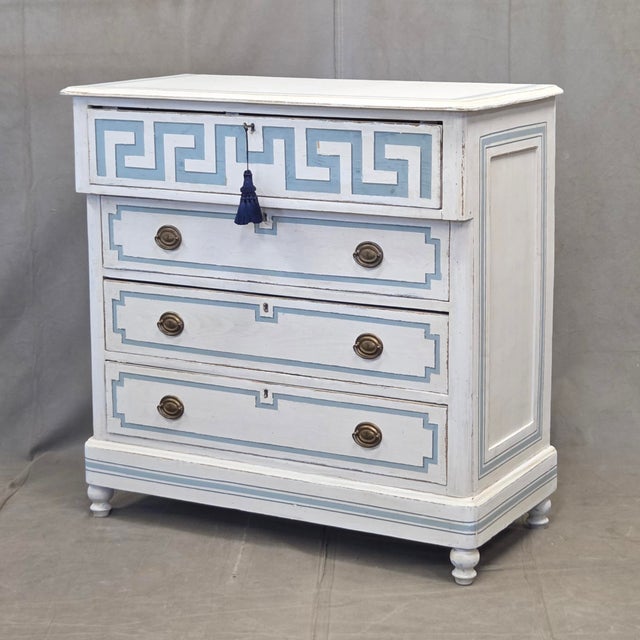 An absolutely stunning antique hand painted pine dresser with distressed antique white paint and blue French line motif....