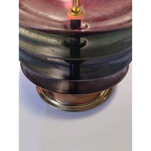 Four Colored Brass Stackable Ashtays with Stand. Blue, green, red and purple ashtrays stacked on a brass stand.