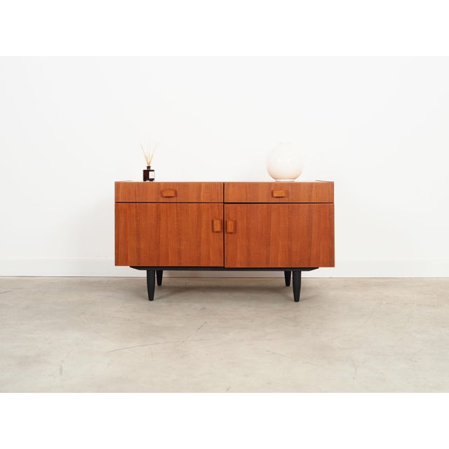 The cabinet was made in the 1970s, produced by the well-known Danish Denka manufactory. The structure is covered with teak...