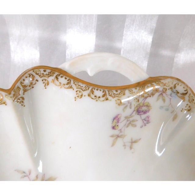 This is a Haviland and Company serving dish in an unknown pink floral pattern. The dish has two backstamps which are dated...