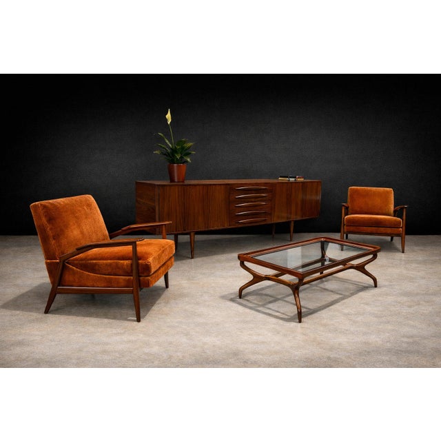 A sculptural and highly refined pair of armchairs by Giuseppe Scapinelli, executed in richly grained Brazilian caviúna...