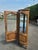 An elegant French Louis XV style cherrywood display cabinet dating from the 20th century. It features a curved glass front...