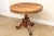 A Victorian occasional or center hall table in an exotic hardwood, with dark veining, pierced apron and an elaborately...