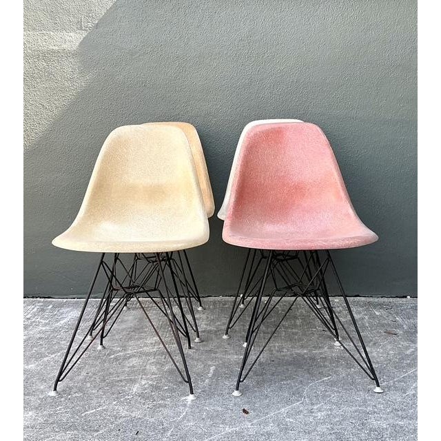 This stunning set of four vintage Eames side chairs for Herman Miller represents a pinnacle of Mid-Century Modern...
