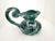 A striking vintage ceramic ewer distinguished by its expressive form and richly textured green, white and dark brown...