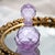 A finely executed Japanese hand-cut glass perfume bottle featuring a faceted spherical form with matching stopper. The...