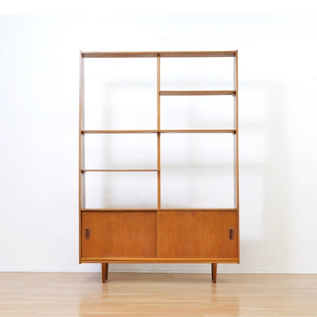 This mid-century bookcase/room divider was designed in England during the 1960s. A slim, delicate bookcase produced in...