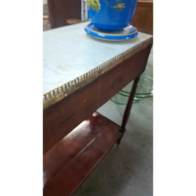 Mahogany console table with a marble top and one drawer. This console table bears a LUNEL stamp under the marble. The...