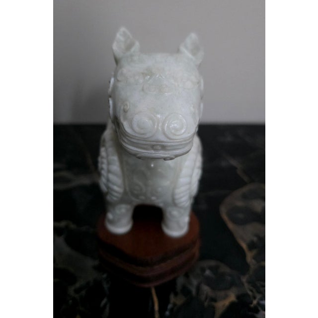 This object is a Chinese white jade zoomorphic incense burner, often referred to as a censer. It is intricately carved...