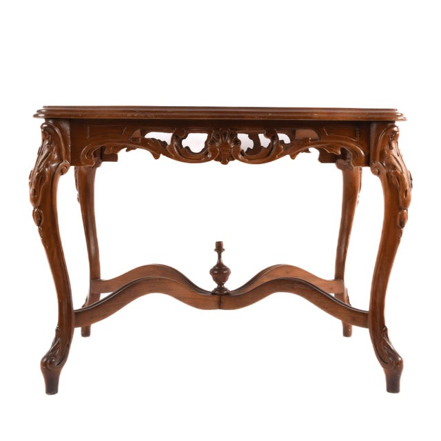 This elegant walnut side table is a stunning example of hand carved craftsmanship, with flowing cabriole legs and...