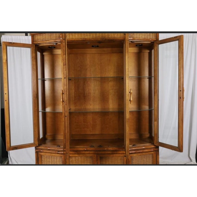 This vintage American of Martinsville faux bamboo and rattan china cabinet is a collector's dream and a rare example of...