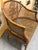 Warm chocolate colored mid-20th century Kindel Furniture (unmarked) Regency-style faux bamboo and cane barrel chair with a...
