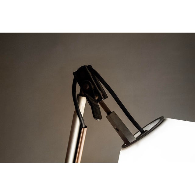 Clamp-on table lamp with painted metal frame and plastic shade. Model: Aggregato Designer: Enzo Mari Manufacturer:...