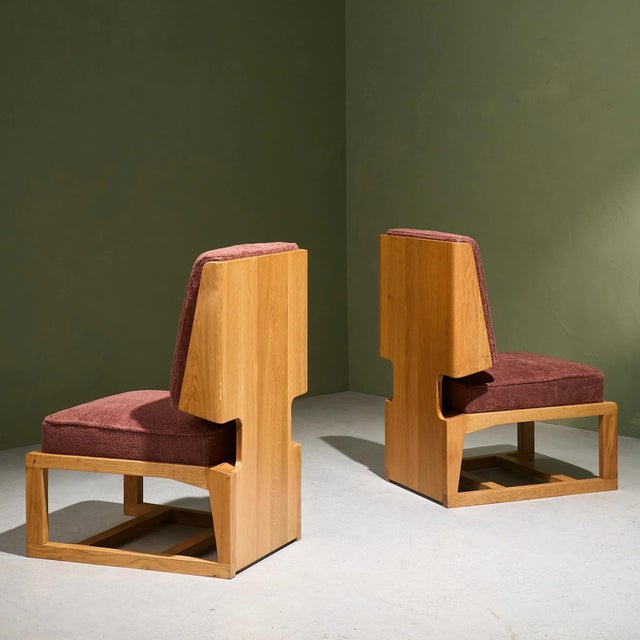 Pair of French Slipper Lounge Chairs from the 1970s. The chairs feature solid oak frames with cubist construction and...