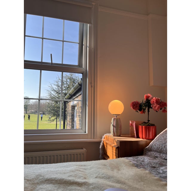 Mcm globe ceramic lamp with dimmable brightness and color temperature. Its very rare 1950s lamp base features a...