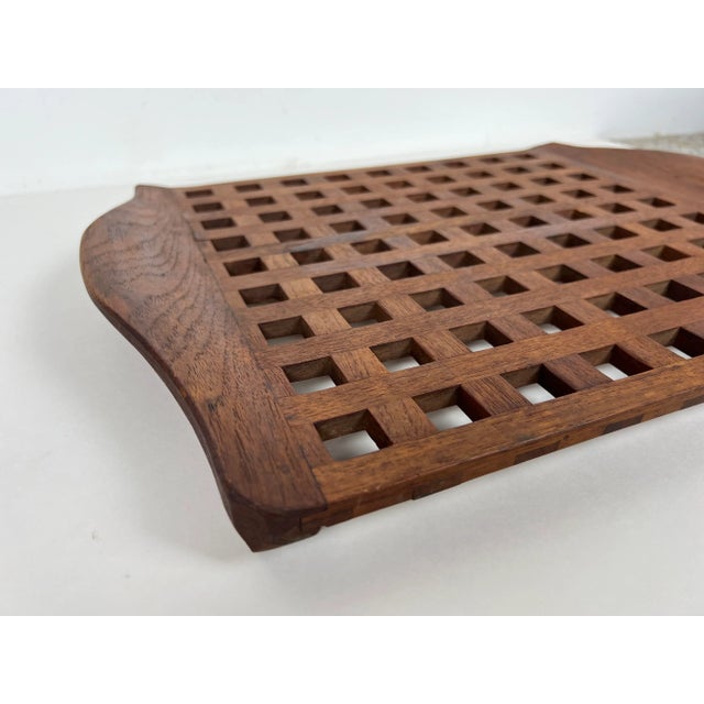 Vintage teak lattice serving tray with sculpted handles designed by Jens Quistgaard for Dansk. There are two versions of...