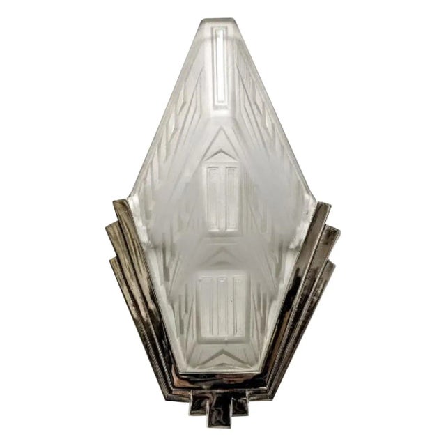 A stunning pair of French Art Deco wall sconces by the French artist “HANOTS “. Each clear frosted molded glass shades are...