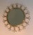 This delicate and decorative sunburst mirror is made of brass and brushed steel. This is a French work. Circa 1970.