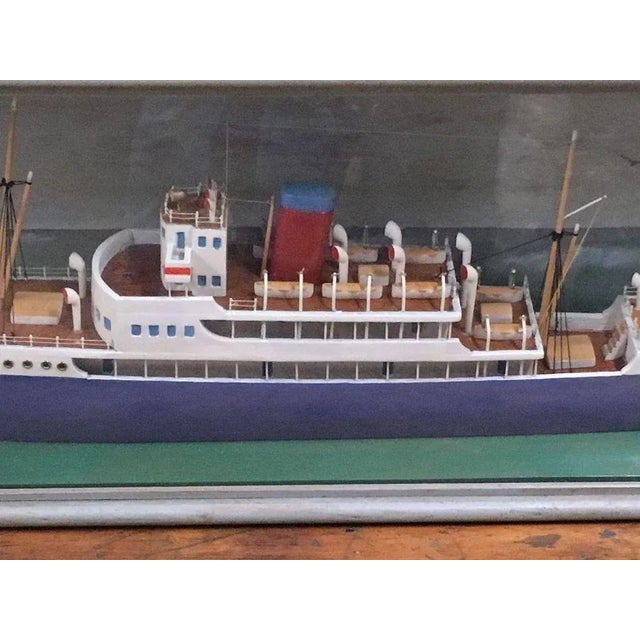 Vintage named ship model in display case. Case is 45 inches long, 15 ¾ inches tall, 9 inches deep. Model is about 36...