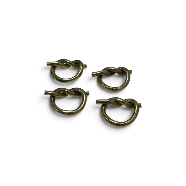 These are solid brass knot napkin rings. They are a set of 4, great condition. They are polished and lacquered.