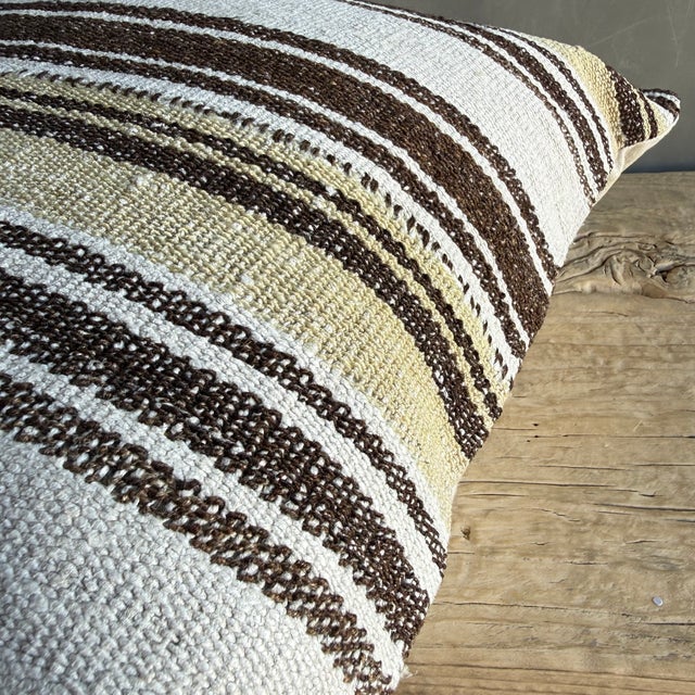 Creamy white hemp rug pillow with stripes. Soft hand, linen blend backing with zipper closure. Spot cleaning is...