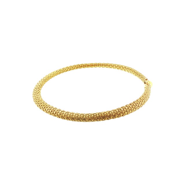 A late 20th-century 18k gold choker necklace with a woven design. The necklace is crafted in Italy. It measures 17.0...