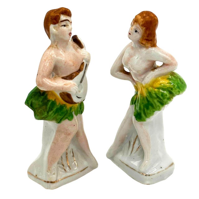 Pair of mid-century dancing hula couple by Okada China, made in Japan. This set Features a female hula dancer alongside a...