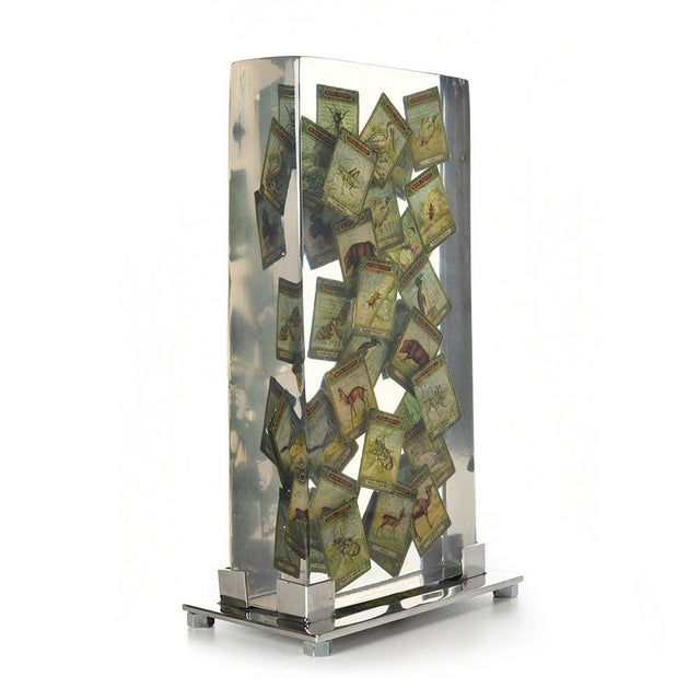 Composition of tokens frozen in the resin. This piece is designed in the style of the selected designer and/or manufacturer