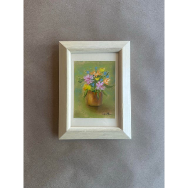 This sweet and cheerful original pastel painting features a vibrant bouquet arranged in a warm-toned vase, set against a...