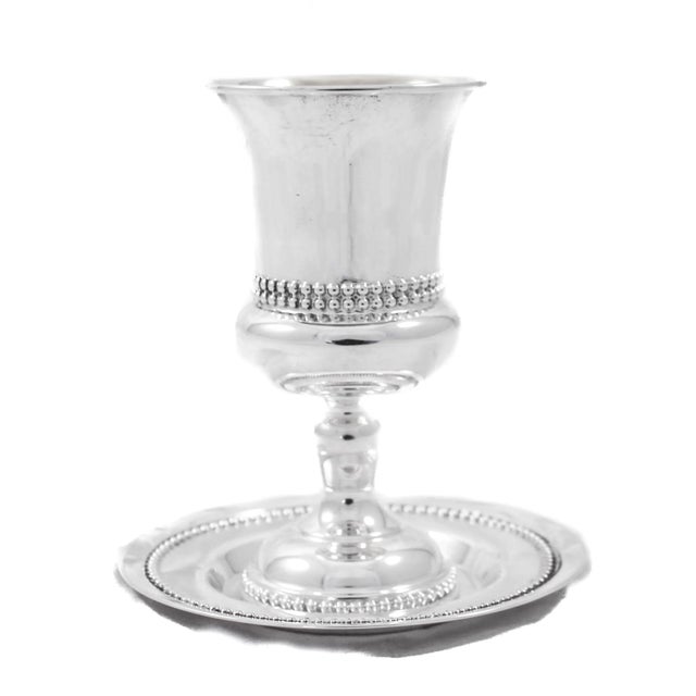 We are happy to offer this sterling silver Kiddush goblet and matching plate, made in Israel. The goblet has a Classic...