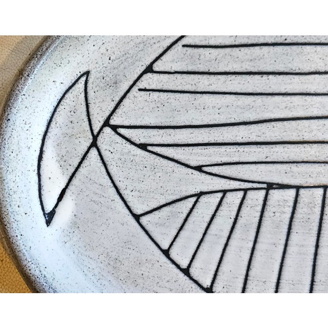 Jacques Pouchain Atelier Dieulefit Stoneware Platter with Incised Fish Motif Circa 1960 This large oval stoneware platter...