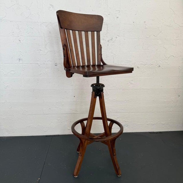This handsome, early 20th century, Arts & Crafts oak swivel architect's stool is circa 1920s. The stool features a slatted...