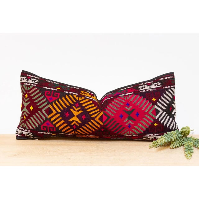 This handcrafted pillow features a vibrant, hand-stitched textile created by the Lakai tribe of Uzbekistan. It is a unique...