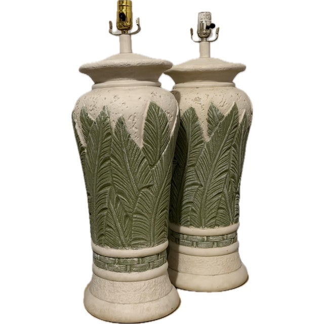 Stunning pair of monumental tropical lamps, perfect colors of green foliage on a cream background. Heavy plaster made...