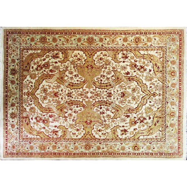 A classical design of swaying palmettes and tendrils emanates from a central blossom. The consistent tone-on-tone...