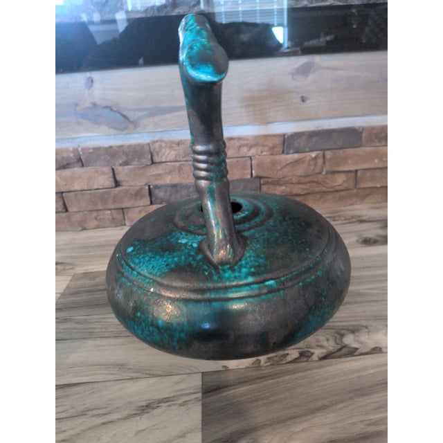 This sculptural studio pottery vessel features a bold, organic form with an arched double-handle design and a rich...