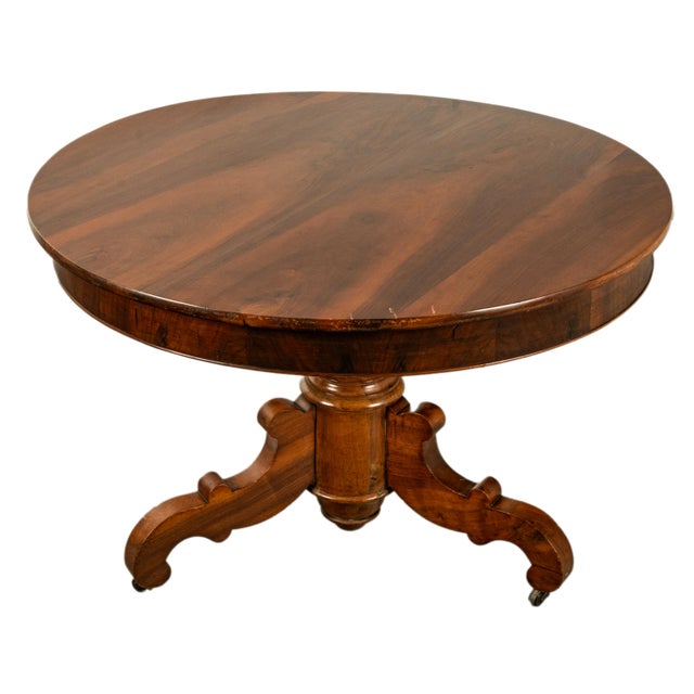 A very good antique French 2nd Empire country style figured walnut round dining or center table, circa 1850. The table is...