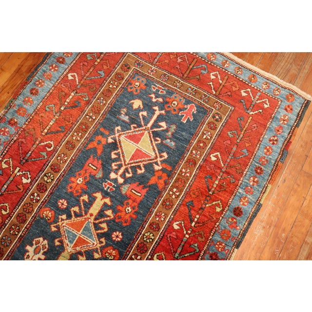 A high quality early 20th century northwest Persian Heriz Serapi wide and long runner. A blue field with 7 unique...