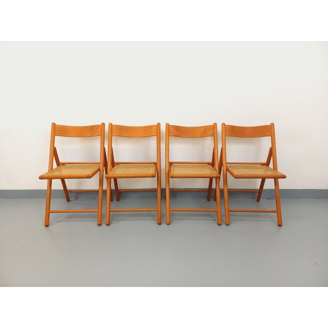 Four vintage folding chairs from the 1980s, designed and manufactured by Habitat, made of beech wood with cane seats. Very...