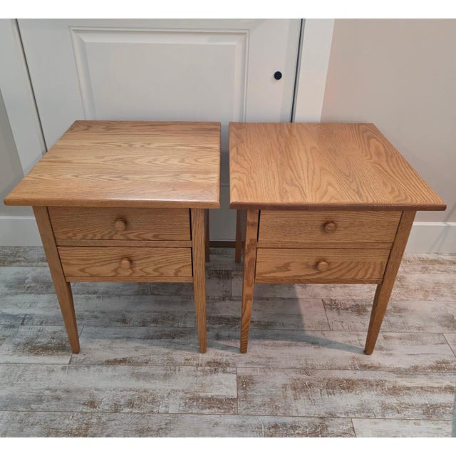 Pair of traditional Shaker style two-drawer end tables crafted by Hunt Country Furniture in the Hudson Valley. Made in...