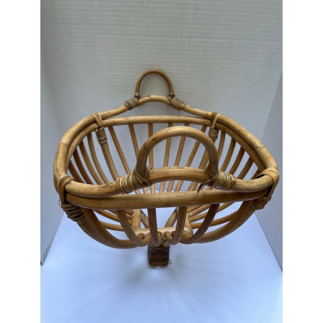 An unusual single bentwood rattan basket with double handles.