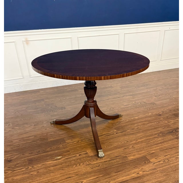 This 42” round mahogany table was made by Leighton Hall in its Suwanee, Georgia facility. It features a field of cathedral...