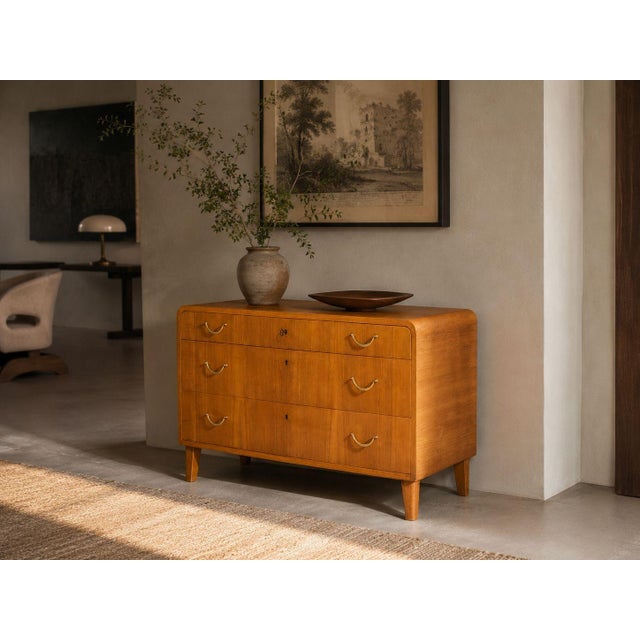 Swedish Mid-Century Modern, Dresser or Chest of Drawers, Elm, Brass, Sweden, 1940s A single dresser designed and produced...
