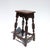 A tall late-19th-century English joint stool with a rectangular single-board seat set above shaped aprons on all four...