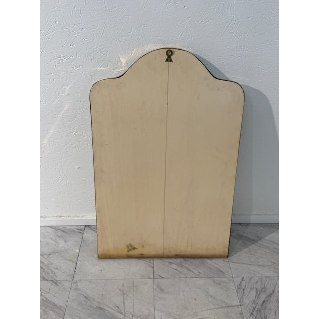 This elegant mid-century Italian wall mirror features a graceful arched silhouette, framed in a slim brass border that...